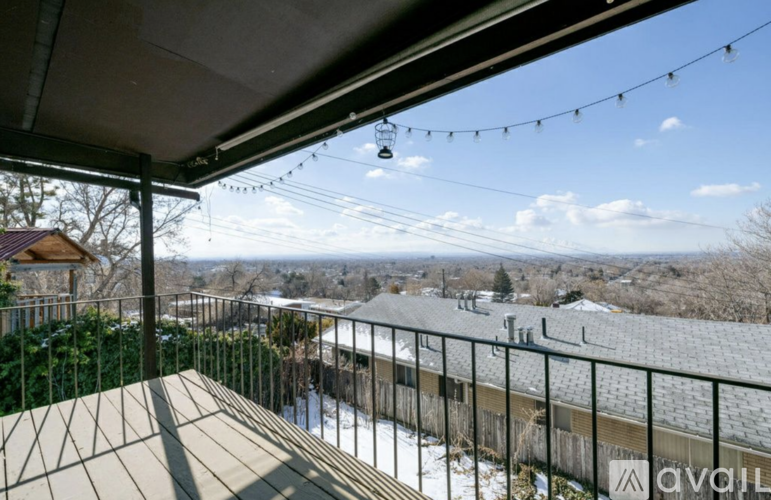 A balcony with a view of a snowy landscape and houses.