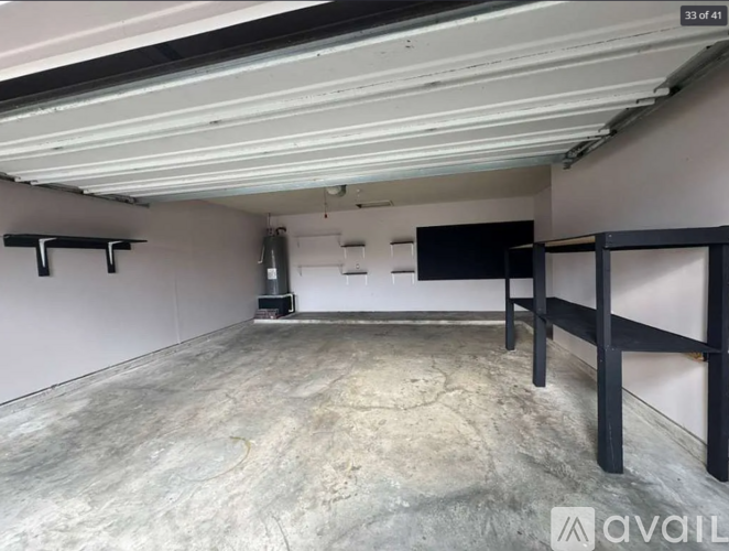A spacious garage with concrete floor and white walls.