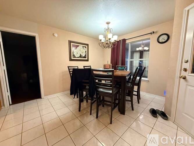 A dining room with a table set for four.