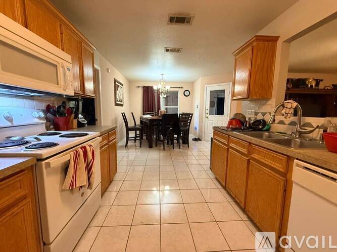 A kitchen with wooden cabinets and white appliances.
