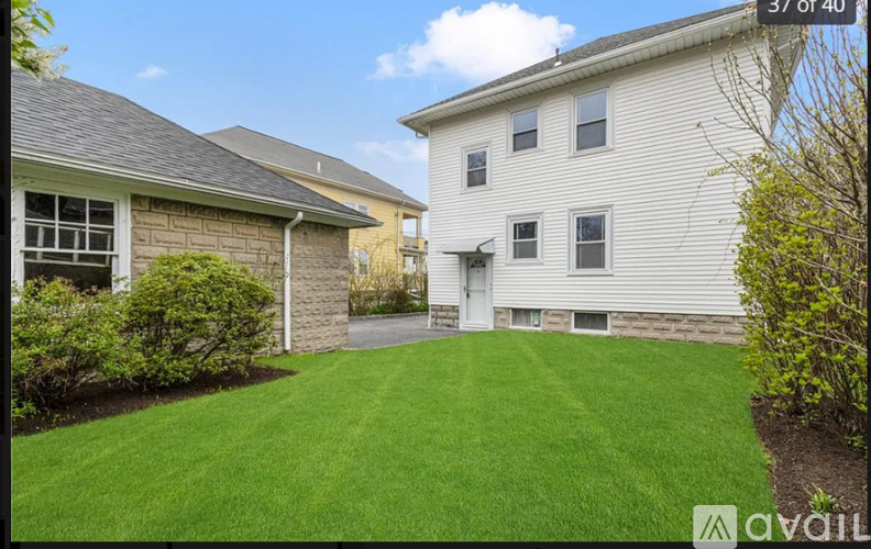A house with a well-maintained lawn is for sale.