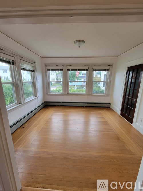 A room with wooden floors and white walls.