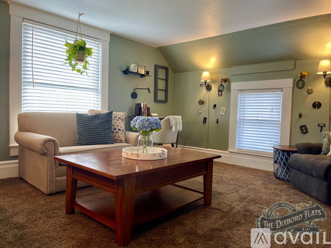 A living room with a couch, chair, and coffee table.