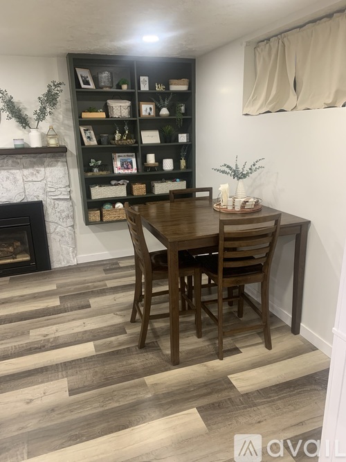 A dining room with a wooden table and chairs.
