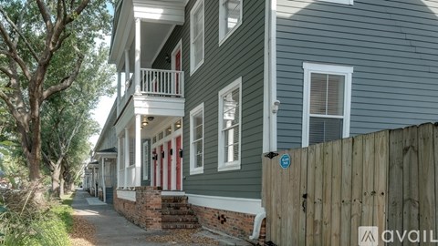 A row of houses with a blue sign on the fence.