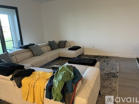 A living room with a couch and a rug.