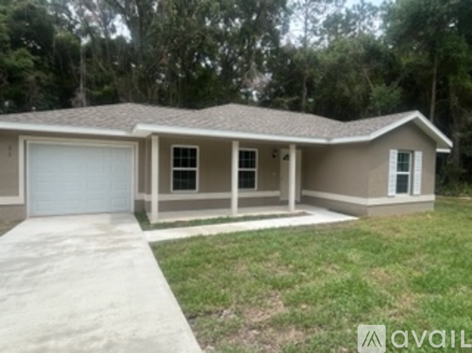 A house with a garage is for sale.