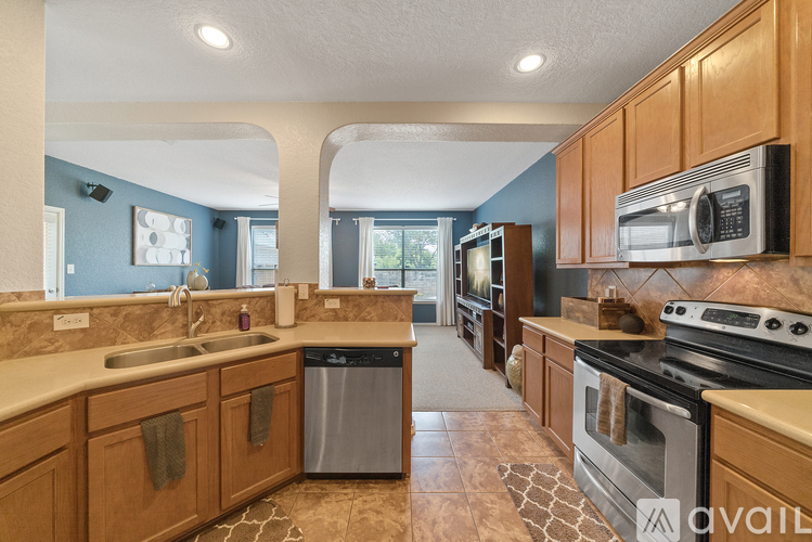 A kitchen with wooden cabinets and a black stove top oven.
