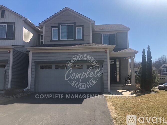 A house with a sign that says "ANAGEMENT COMPLETE SERVICES" in front of it.