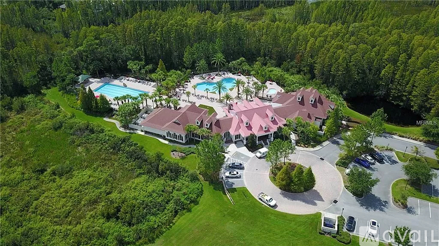 A bird's eye view of a resort with a swimming pool and a large house.