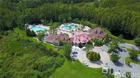 A bird's eye view of a resort with a swimming pool and a large house.
