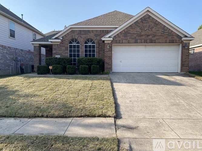 A house with a garage and a driveway.