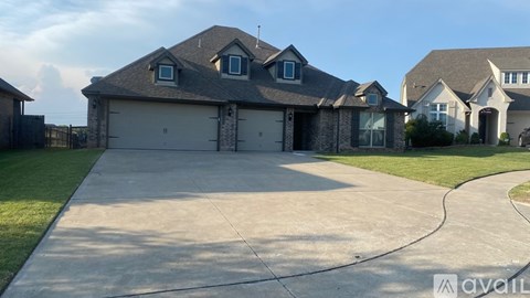 A house with a garage and a driveway is available for sale.