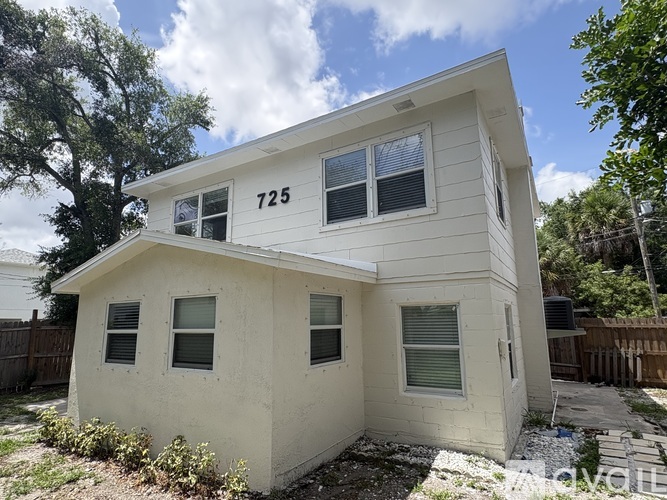 A two-story house with the number 725 on the front.