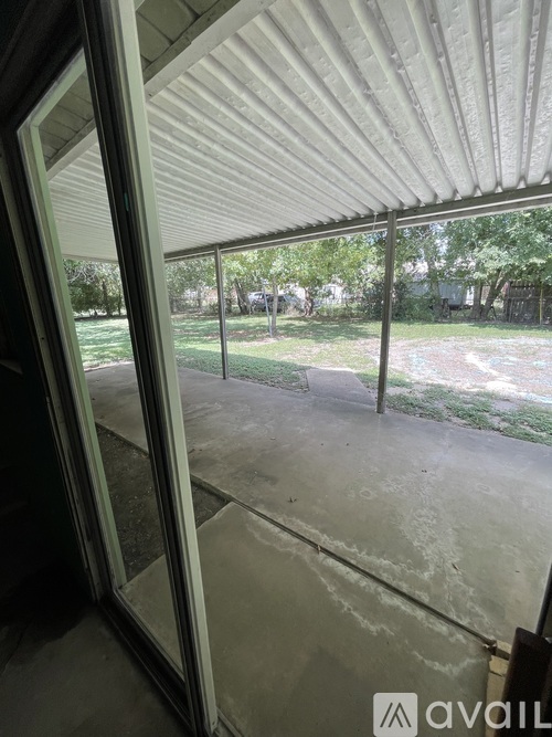 A view from inside a building looking out through a sliding glass door.