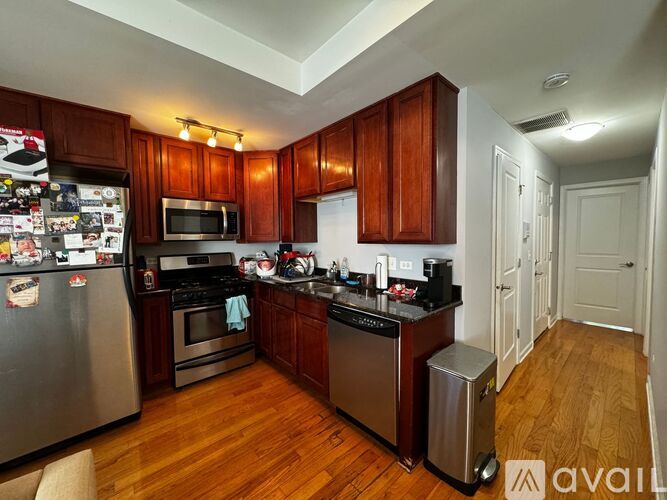 A kitchen with wooden cabinets and stainless steel appliances.