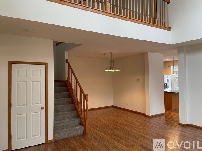 A living room with a staircase and a door.
