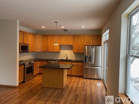 A kitchen with wooden cabinets and a central island.