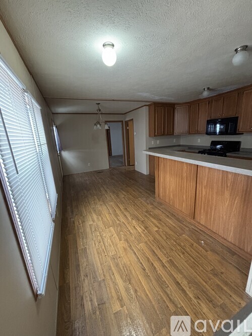 A kitchen with wooden floors and a countertop.