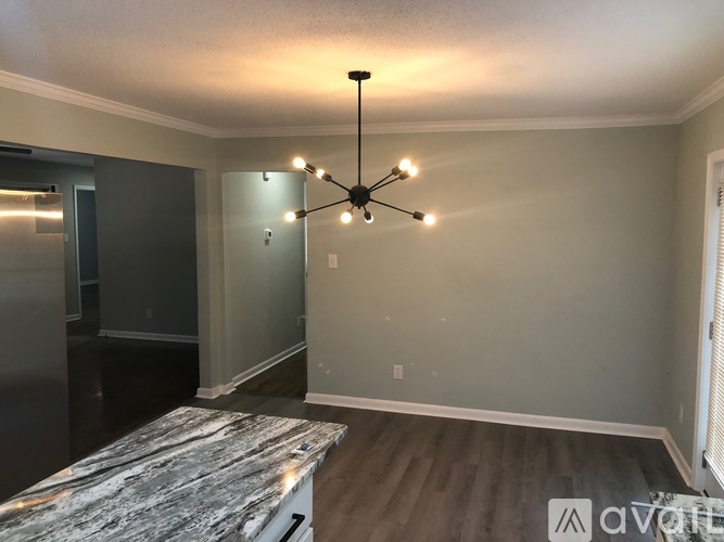 A modern room with a marble table and a ceiling fan.