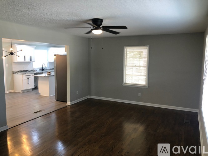 A room with a ceiling fan and a window.