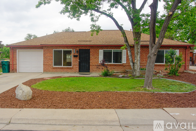 A house with a red brick exterior and a white garage door.