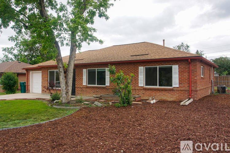A house with a red brick exterior and a brown roof is for sale.