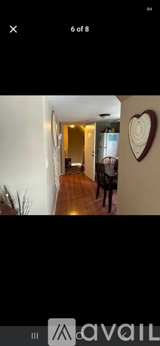 A heart-shaped decoration hangs on a wall.