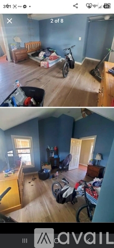 A room with a bicycle and a vacuum cleaner.
