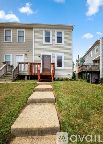 A house with a brown door and a wooden deck.