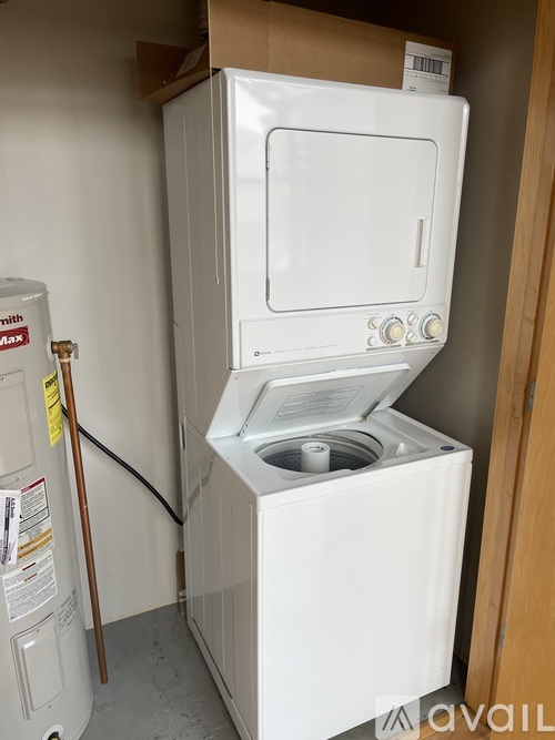 A white oven with a door open is in a room.