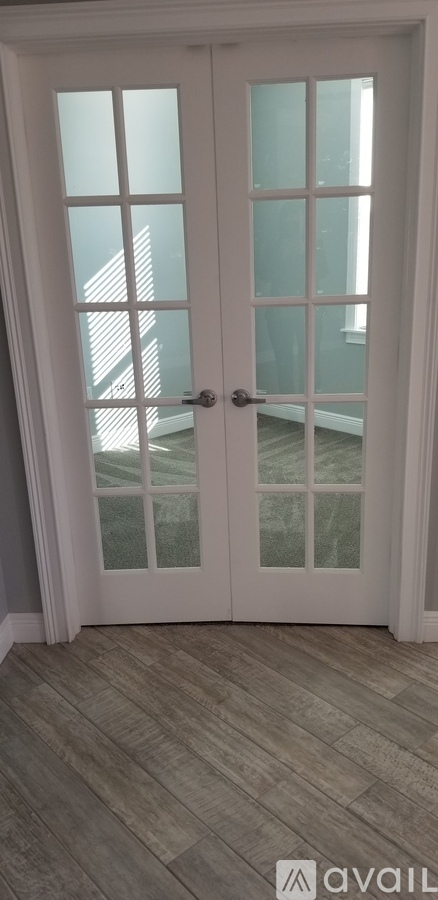 A white double door with glass panels and a handle.