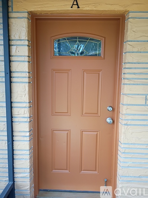 A brown door with a glass window above it.