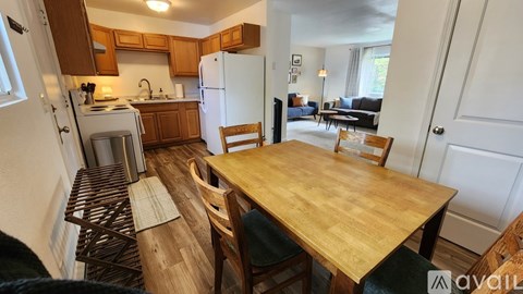 A kitchen with a table and chairs in the middle of the room.