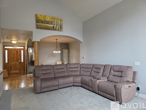 A large grey sectional sofa in a spacious living room.