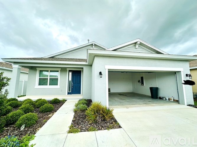 A two-story house with a garage and a blue door.