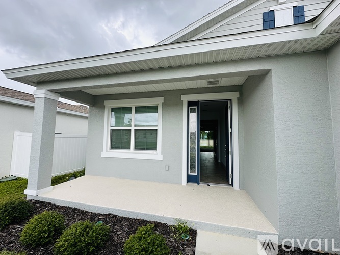 A house with a grey front and a white door.