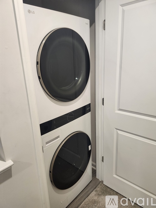 A white LG front loading washing machine in a laundry room.