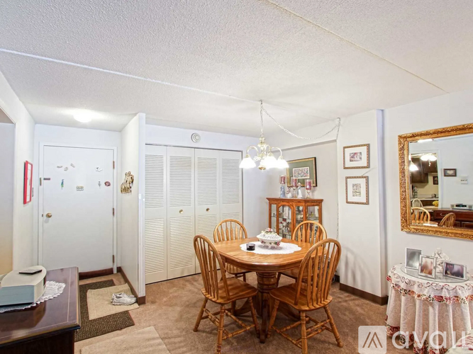 A dining room with a wooden table and chairs.