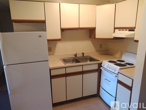 A kitchen with white appliances and cabinets.