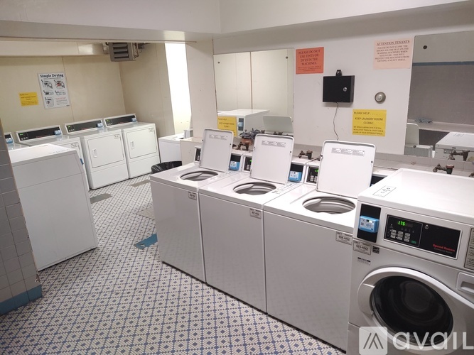 A row of washing machines in a public laundromat.