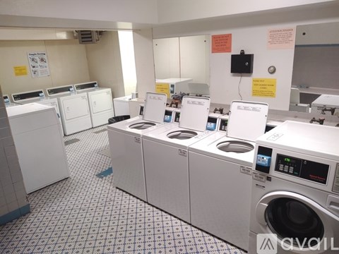 A row of washing machines in a public laundromat.