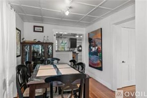 A dining room with a wooden table and chairs.