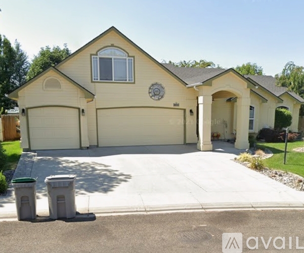 A house with a garage and a driveway in front.