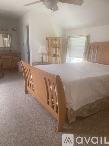 A bedroom with a large bed and a dresser.