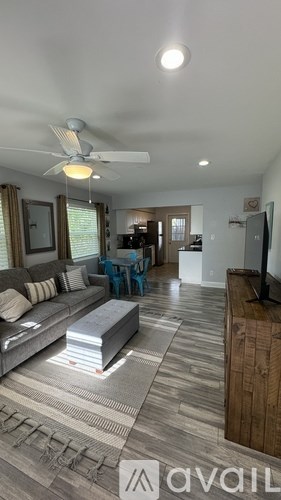 A living room with a grey sofa and a wooden coffee table.