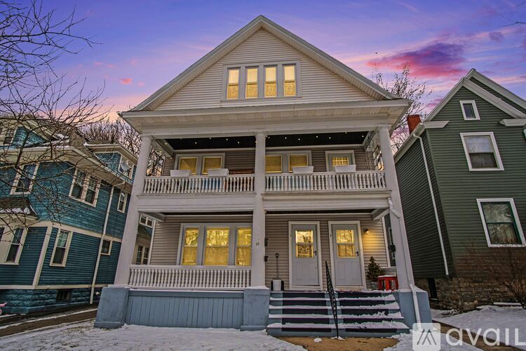 A two-story house with a front porch is available for sale.