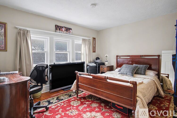 A bedroom with a large bed and a desk with a computer.