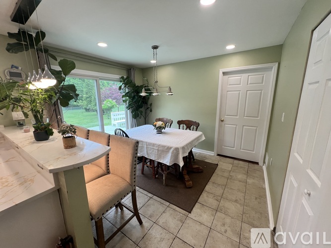 A dining area with a table and chairs.
