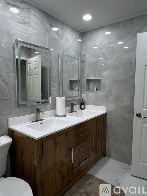A bathroom with a white sink and a toilet.